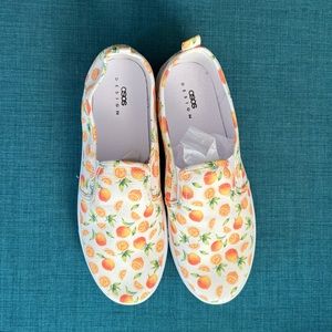 Orange- print slip on plimsolls - new- size 10